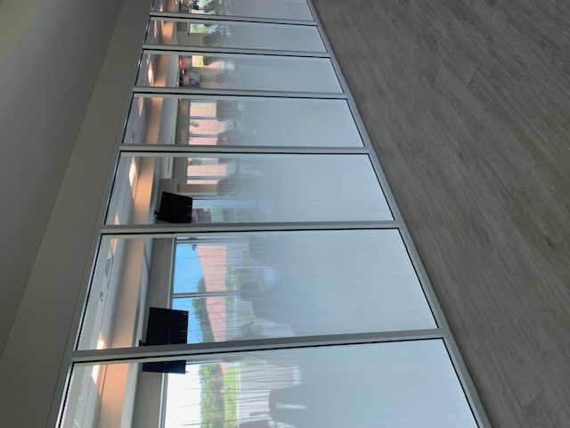 Privacy film installed on a commercial glass office partition