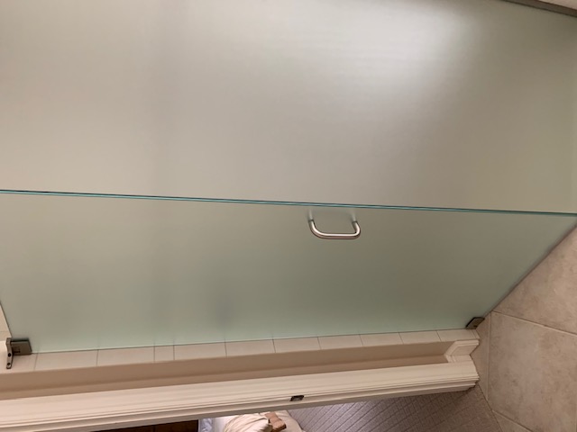 Frosted privacy film on an interior glass shower door